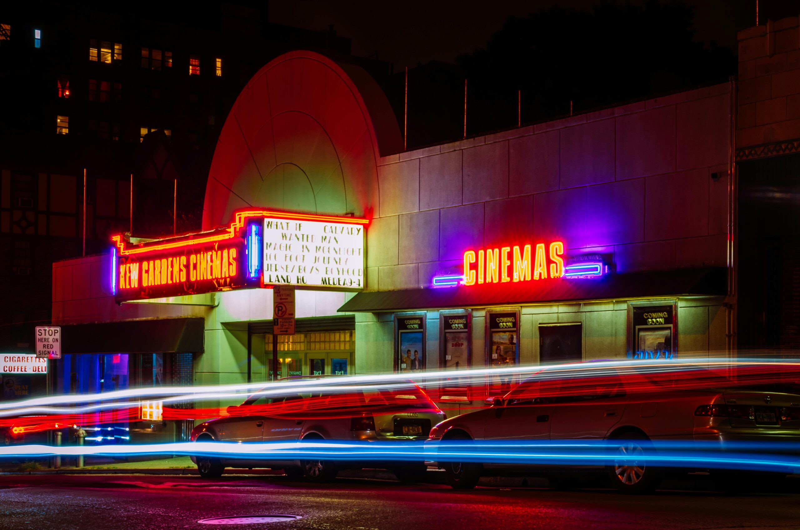 pexels-photo-436413-436413 Vibrant night view of New Gardens Cinemas in Queens, New York with colorful neon lights and light streaks.