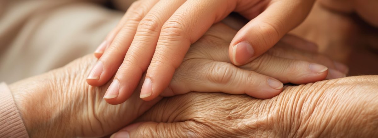 Compassionate female caregiver gently holds elderly woman hand in loving care. Warm smile on carer face conveys comfort and hope. Elderly person with wrinkled hands rests in trust. Compassionate female caregiver gently holds elderly woman hand in loving care. Warm smile on carer face conveys comfort and hope. Elderly person with wrinkled hands, rests in trust.